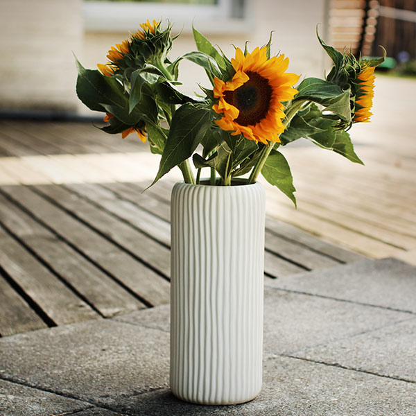 Naturfoto mit Sonnenblumen in Vase, die draussen steht